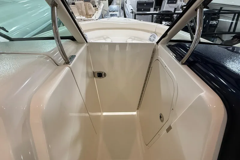 Slide: The Image of 2014 Pursuit DC 265 Dual Console boat interior with storage compartment. - 53
