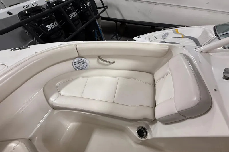 Slide: The Image of 2014 Pursuit DC 265 Dual Console boat interior with white seating and speaker. - 56
