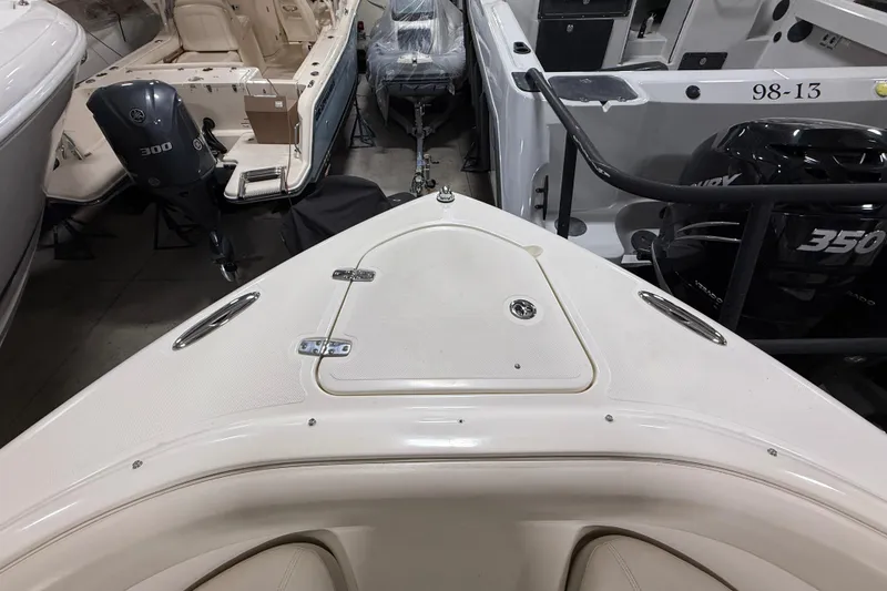 Slide: The Image of 2014 Pursuit DC 265 Dual Console boat interior with outboard motors in storage. - 57