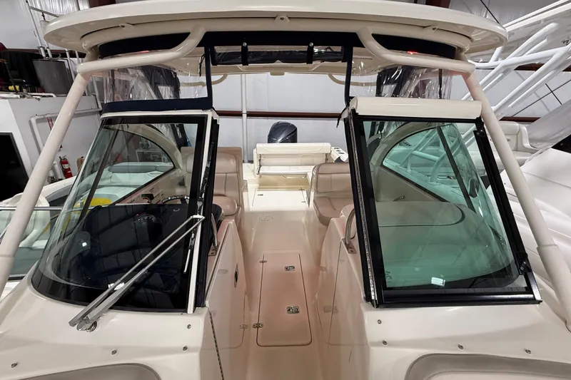 Slide: The Image of 2014 Pursuit DC 265 Dual Console boat interior with seating and windshield. - 60