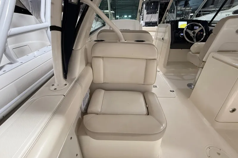 Slide: The Image of 2014 Pursuit DC 265 Dual Console boat in storage, side view. - 7