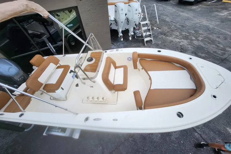 Slide: The Image of 2026 Pioneer 180 Islander boat with tan seating and modern design. - 10