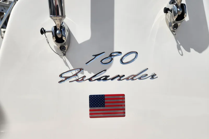 Slide: The Image of 2026 Pioneer 180 Islander boat emblem with American flag detail. - 6