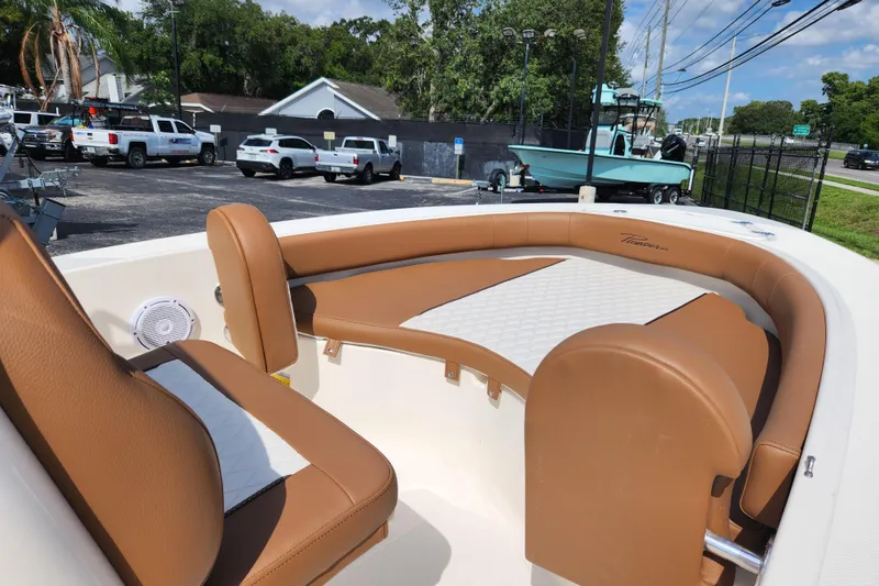 Slide: The Image of 2026 Pioneer 180 Islander boat interior with tan seating and white accents. - 8