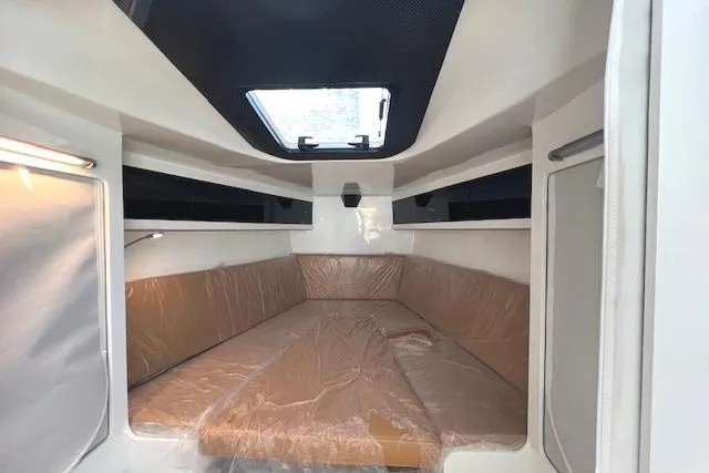 Slide: The Image of Interior cabin of 2024 Neo 43 Romo boat with brown seating and overhead window. - 10