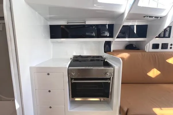 Slide: The Image of Modern kitchen area in 2024 Neo 43 Romo yacht with stove and seating. - 8