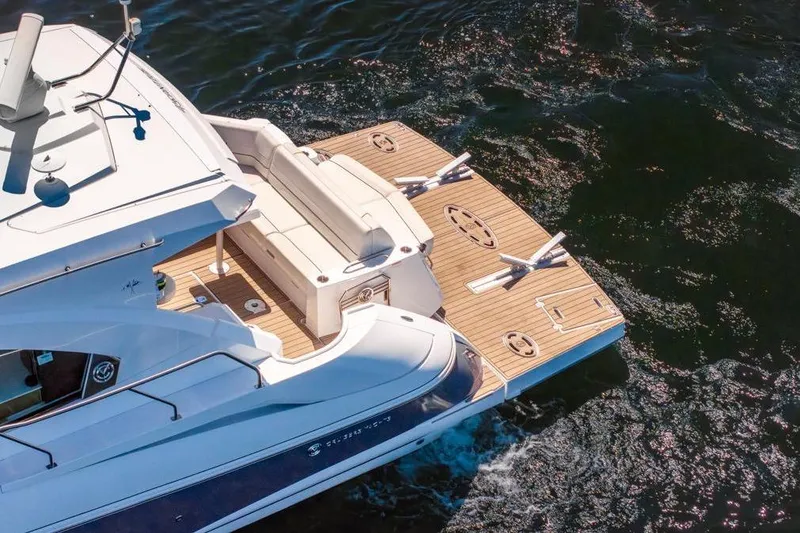 Slide: The Image of 2017 Cruisers Yachts 45 Cantius on water, featuring spacious deck and seating area. - 12