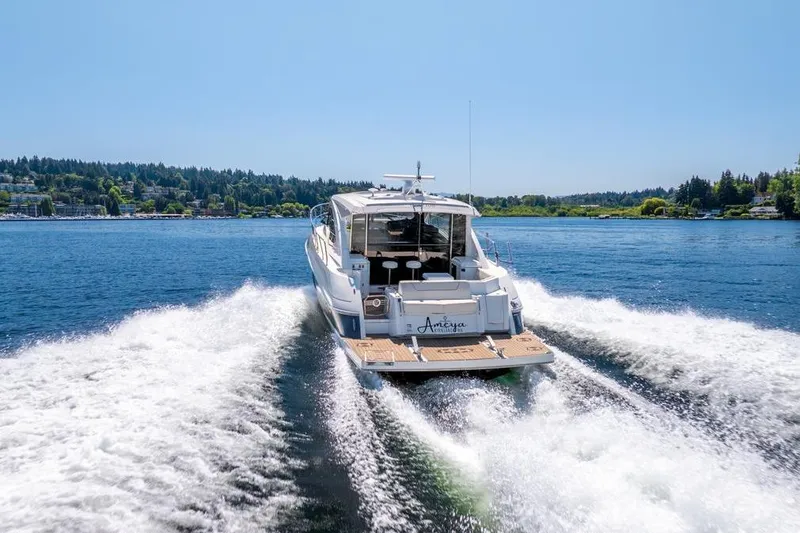 Slide: The Image of 2017 Cruisers Yachts 45 Cantius cruising on a sunny lake, creating a wake. - 4