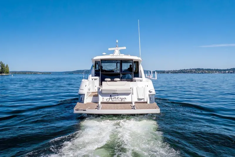 Slide: The Image of 2017 Cruisers Yachts 45 Cantius on serene lake under clear blue sky. - 5