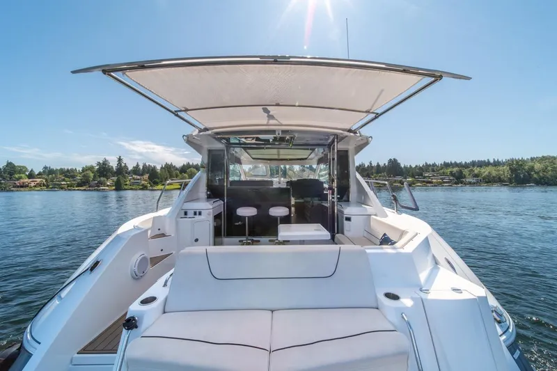 Slide: The Image of 2017 Cruisers Yachts 45 Cantius on serene lake, featuring spacious deck and modern design. - 11