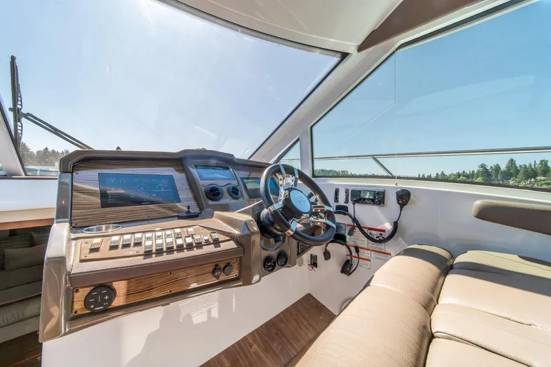 Slide: The Image of 2017 Cruisers Yachts 45 Cantius helm with modern controls and panoramic view. - 19