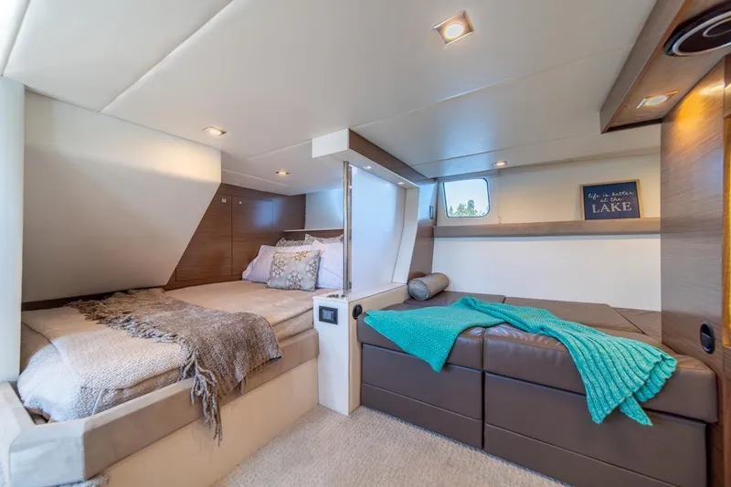 Slide: The Image of Luxurious 2017 Cruisers Yachts 45 Cantius cabin interior with cozy bedding and modern decor. - 33