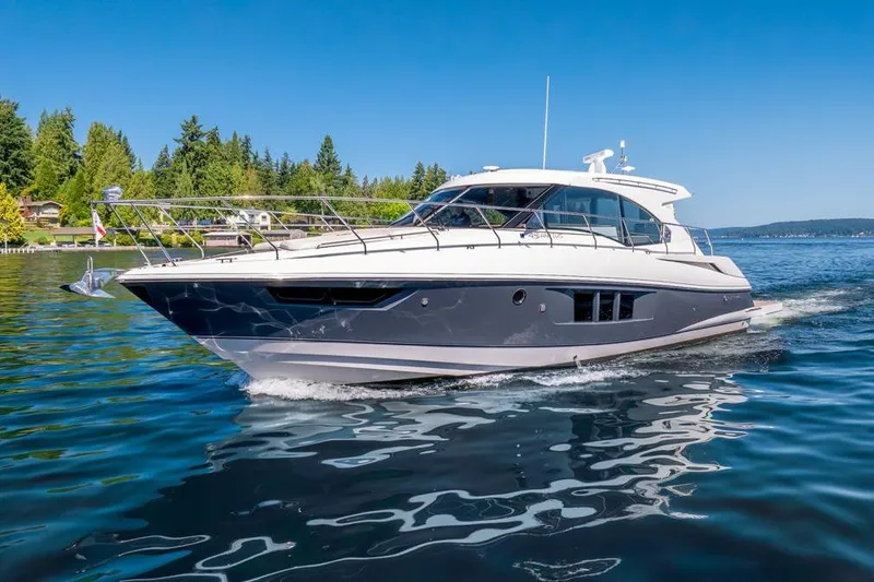 Slide: The Image of 2017 Cruisers Yachts 45 Cantius cruising on a serene lake under clear blue skies. - 9