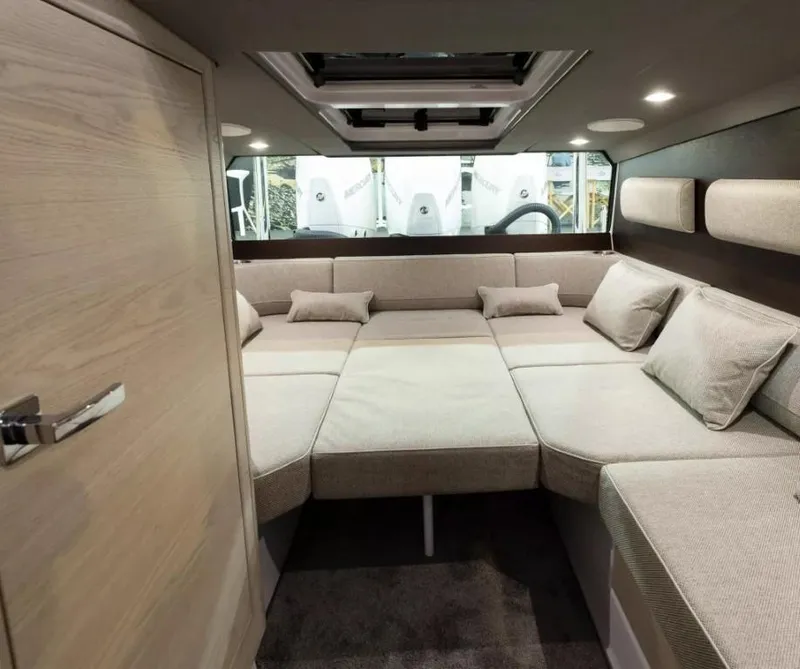 Slide: The Image of Interior cabin of 2025 Axopar 45 Cross Top, featuring a spacious, modern seating area. - 14