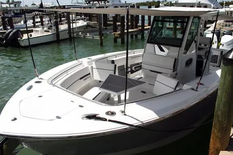 Slide: The Image of Manufacturer Provided Image: 2026 Blackfin 302 CC boat docked in marina, featuring sleek design and spacious deck. - 2
