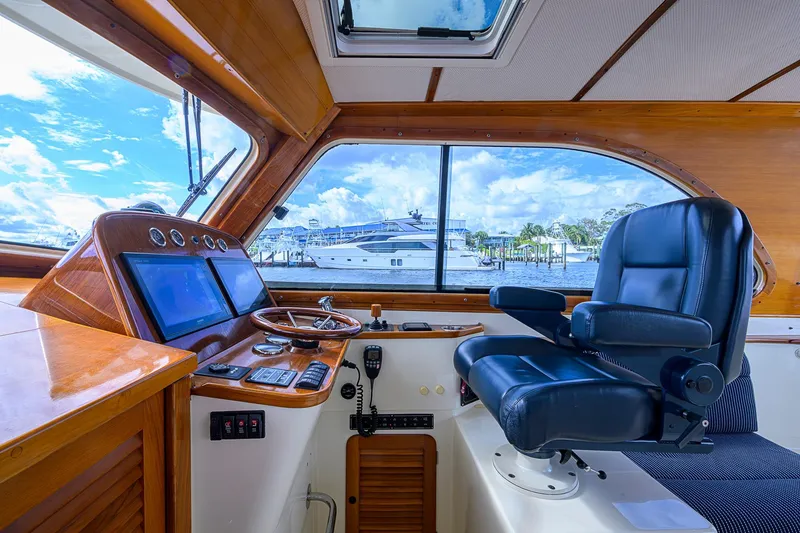 Slide: The Image of Interior helm of 2006 Hinckley Talaria 40 yacht with leather captain's chair and navigation controls. - 13