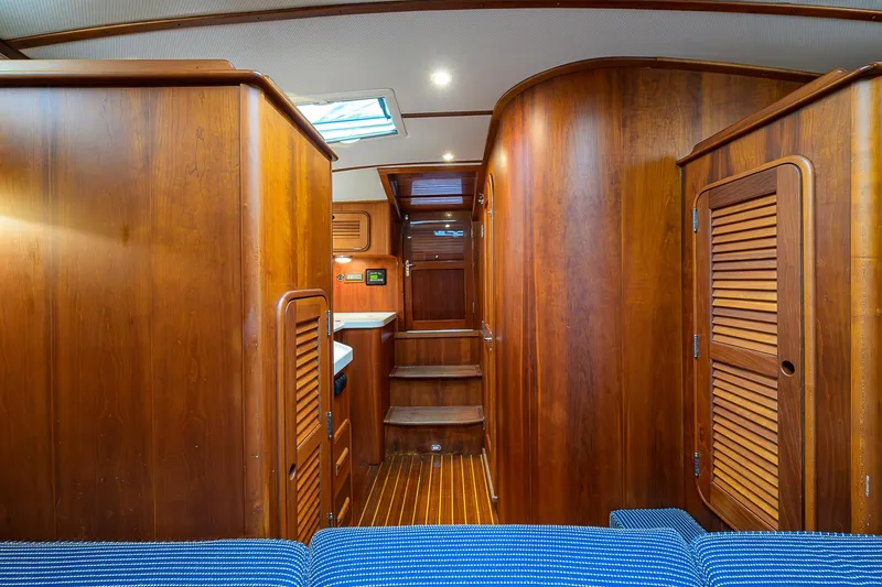 Slide: The Image of Interior of 2006 Hinckley Talaria 40 yacht with wooden cabinetry and blue seating. - 15
