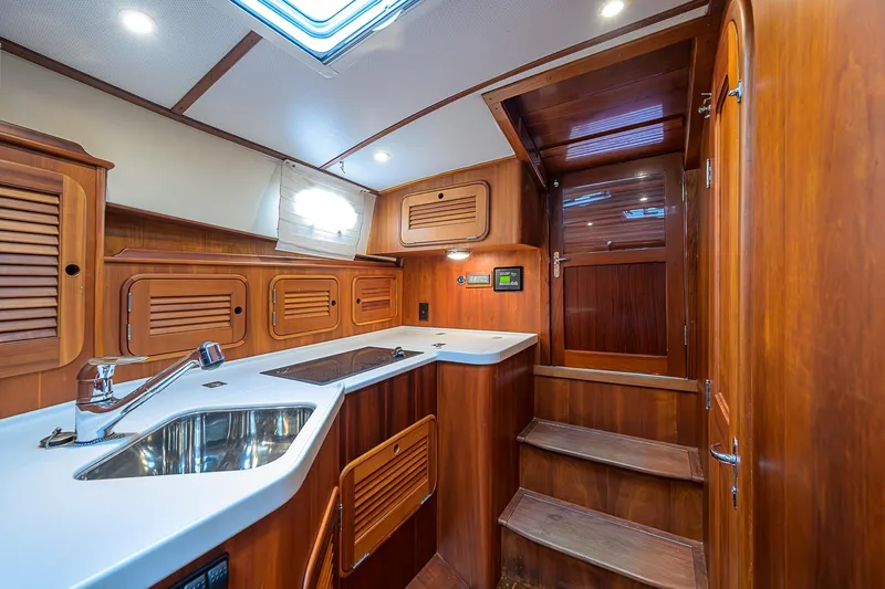 Slide: The Image of Luxurious 2006 Hinckley Talaria 40 yacht interior with elegant wood cabinetry and modern amenities. - 16
