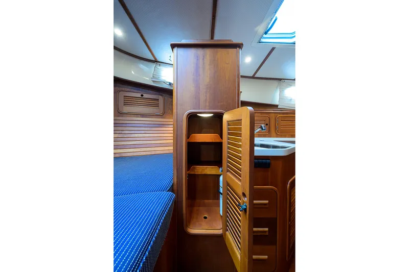 Slide: The Image of Interior of 2006 Hinckley Talaria 40 yacht with wooden cabinetry and blue upholstery. - 20