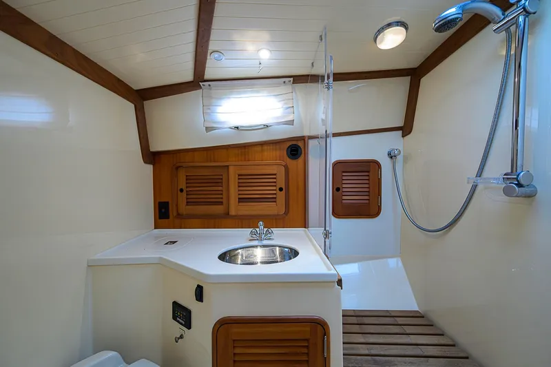 Slide: The Image of Luxurious 2006 Hinckley Talaria 40 yacht bathroom with wooden accents and modern fixtures. - 21