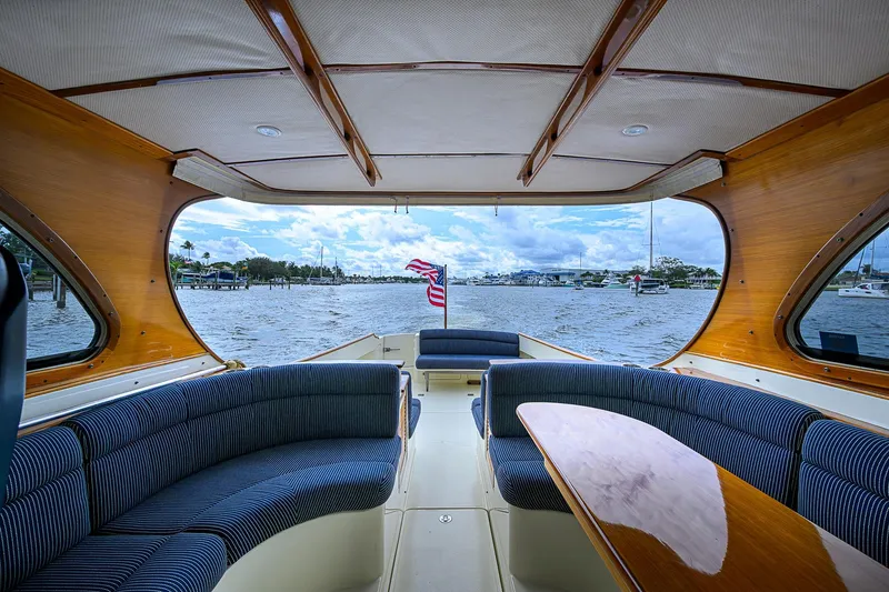Slide: The Image of Interior view of 2006 Hinckley Talaria 40 yacht with elegant seating and scenic water backdrop. - 10