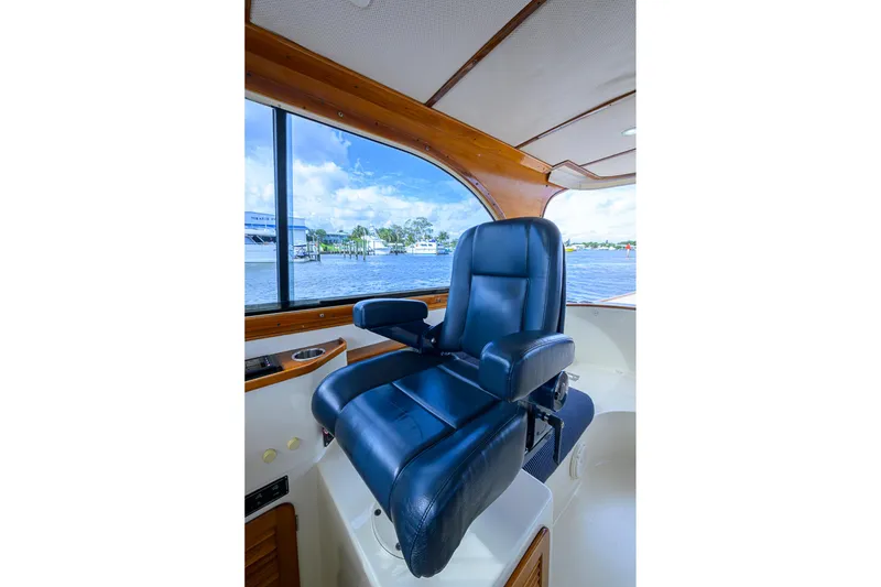 Slide: The Image of Captain's chair on 2006 Hinckley Talaria 40 yacht, overlooking scenic waterfront. - 11