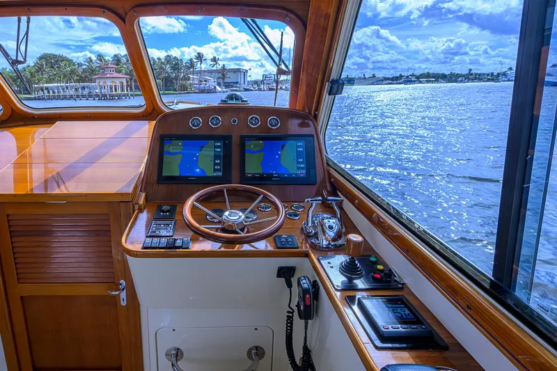 Slide: The Image of Helm of 2006 Hinckley Talaria 40 yacht with navigation screens and wooden steering wheel. - 14
