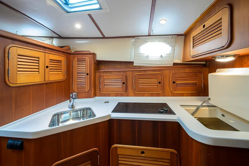 Slide: The Image of Luxurious 2006 Hinckley Talaria 40 yacht kitchen with wooden cabinets and modern amenities. - 17