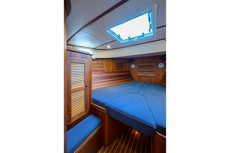 Slide: The Image of Luxurious 2006 Hinckley Talaria 40 cabin interior with wood paneling and skylight. - 19