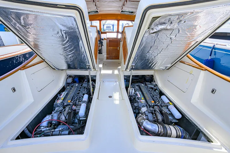 Slide: The Image of 2006 Hinckley Talaria 40 engine compartment with open hatches, showcasing dual engines. - 25