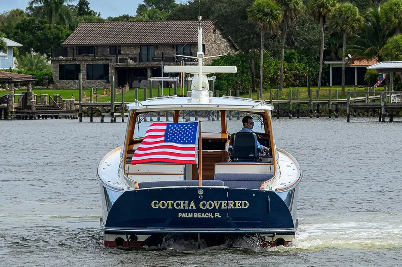 Slide: The Image of 2006 Hinckley Talaria 40 yacht cruising with American flag, Palm Beach backdrop. - 4