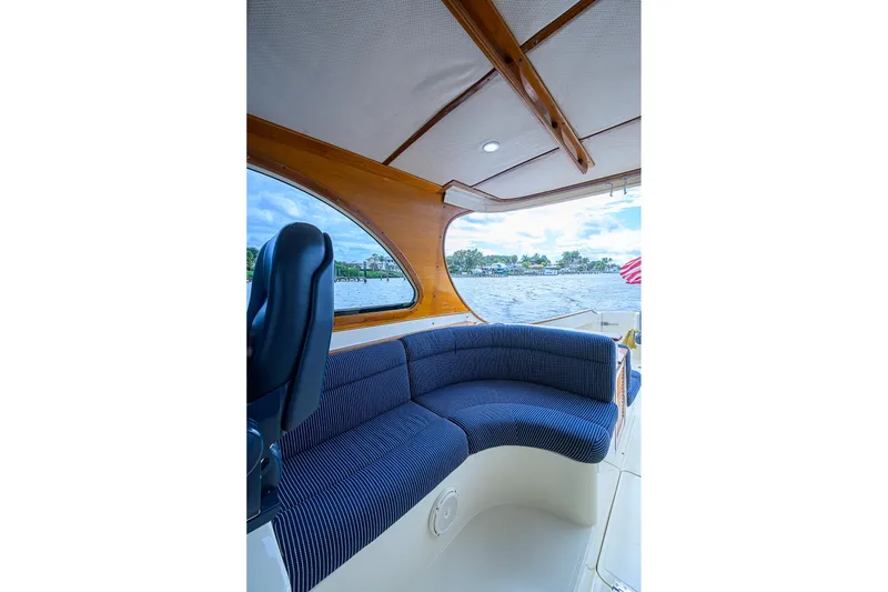 Slide: The Image of Interior of 2006 Hinckley Talaria 40 yacht with blue seating and wooden accents. - 9