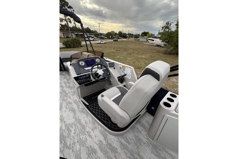 Slide: The Image of 2026 Starcraft SLS 3DL DH BAR boat interior with steering wheel and seating. - 10