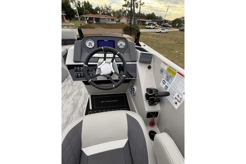 Slide: The Image of 2026 Starcraft SLS 3DL DH BAR boat dashboard with steering wheel and controls. - 11