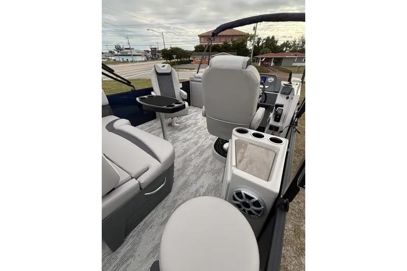 Slide: The Image of 2026 Starcraft SLS 3DL DH BAR boat interior with seating and control panel. - 13