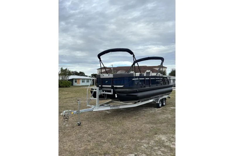 Slide: The Image of 2026 Starcraft SLS 3DL DH BAR pontoon boat on trailer, parked outdoors. - 4