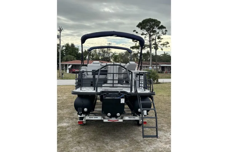 Slide: The Image of 2026 Starcraft SLS 3DL DH BAR pontoon boat with canopy, parked on grass. - 6