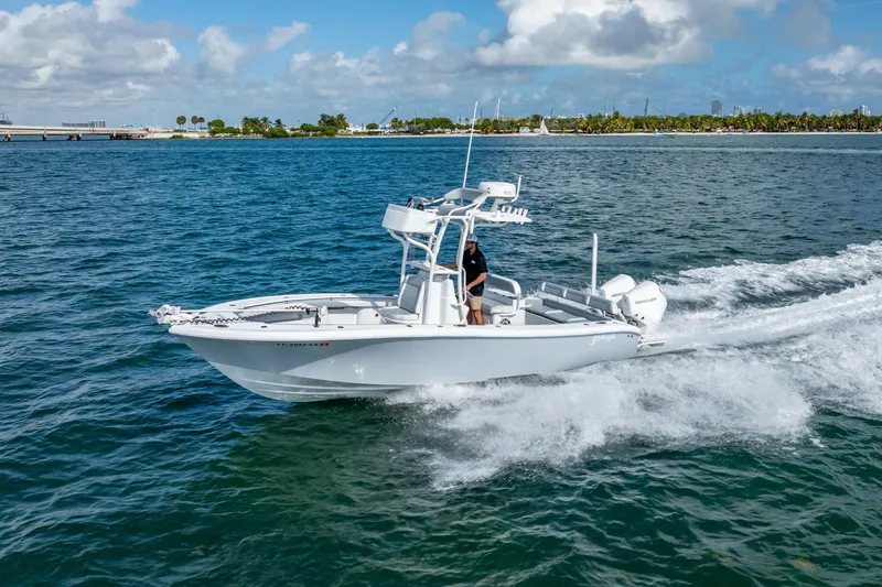 Slide: The Image of 2021 Yellowfin 26 Hybrid boat cruising on open water under a clear sky. - 18