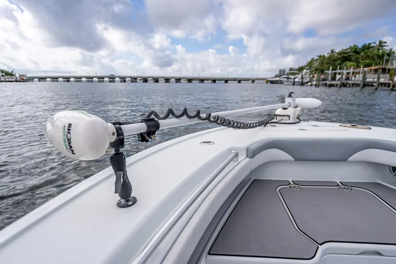 Slide: The Image of 2021 Yellowfin 26 Hybrid boat with trolling motor on calm water. - 22