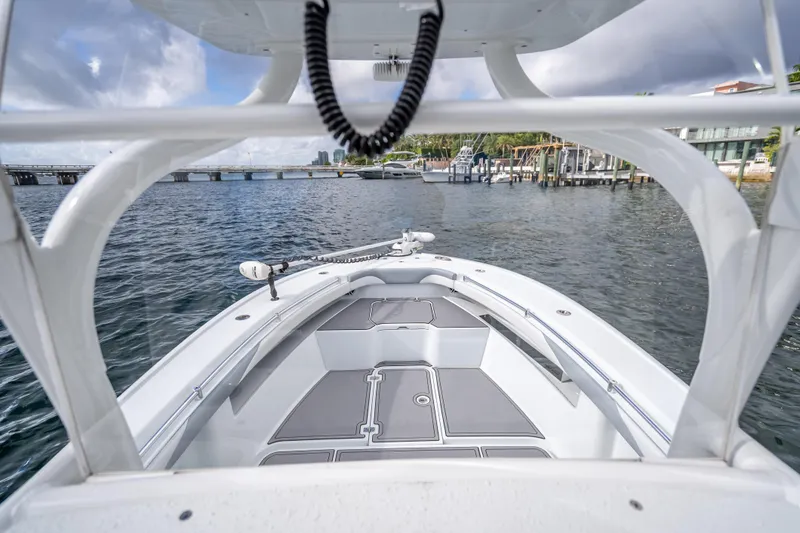 Slide: The Image of 2021 Yellowfin 26 Hybrid boat on water, showcasing sleek design and spacious deck. - 32