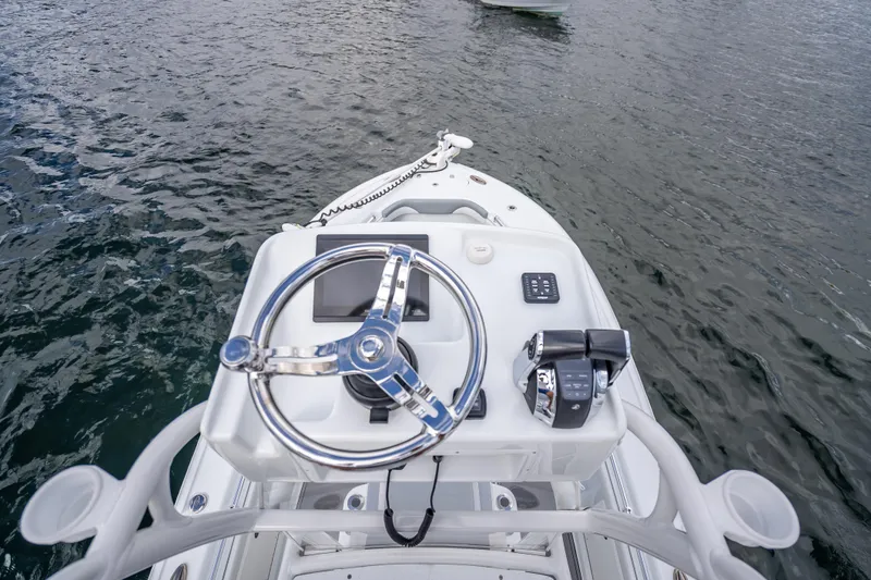 Slide: The Image of Steering console of 2021 Yellowfin 26 Hybrid boat on water. - 34