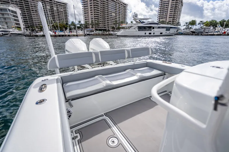 Slide: The Image of 2021 Yellowfin 26 Hybrid boat interior with marina view, featuring dual Mercury engines. - 37