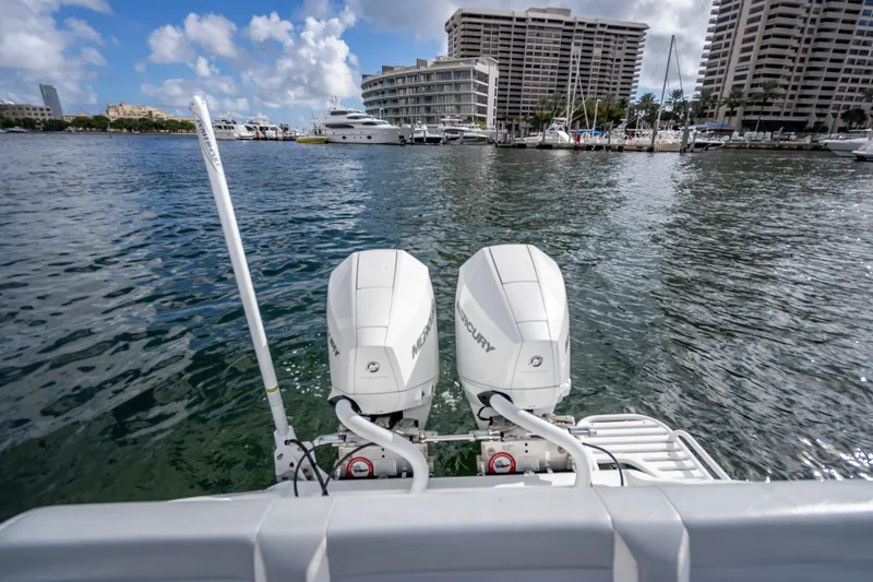 Slide: The Image of 2021 Yellowfin 26 Hybrid boat with dual Mercury outboard engines in a marina setting. - 40