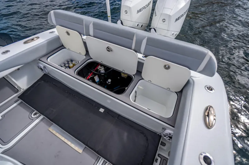 Slide: The Image of 2021 Yellowfin 26 Hybrid boat with open storage compartments and twin Mercury engines. - 43