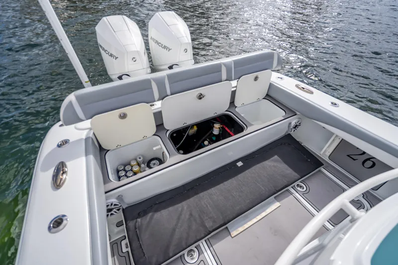 Slide: The Image of 2021 Yellowfin 26 Hybrid boat with open storage compartments and twin Mercury engines. - 44