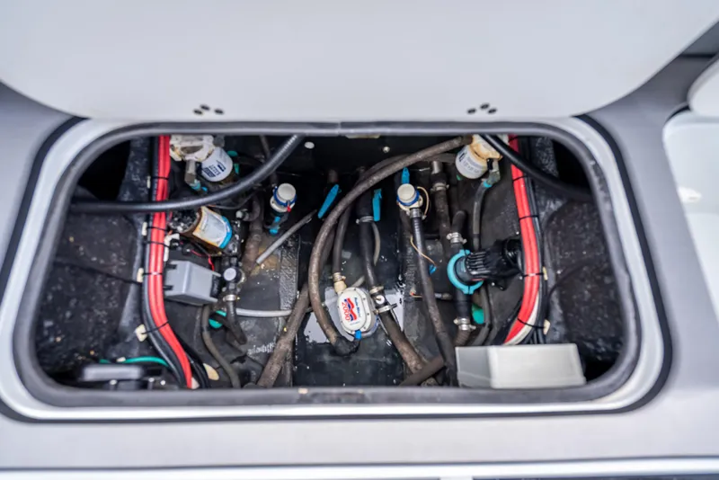 Slide: The Image of 2021 Yellowfin 26 Hybrid boat compartment with wiring and plumbing components. - 45