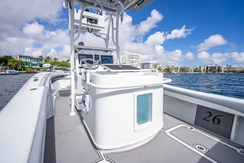 Slide: The Image of 2021 Yellowfin 26 Hybrid boat on water, featuring sleek design and modern controls. - 46