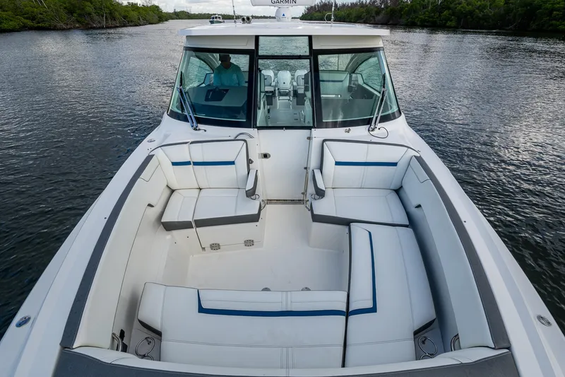 Slide: The Image of 2021 Tiara Yachts 38 LX with spacious seating on a calm waterway. - 10
