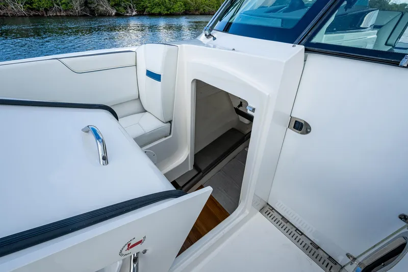 Slide: The Image of 2021 Tiara Yachts 38 LX interior view with seating and cabin entrance. - 12