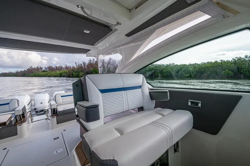 Slide: The Image of 2021 Tiara Yachts 38 LX interior with luxurious seating and scenic water view. - 20